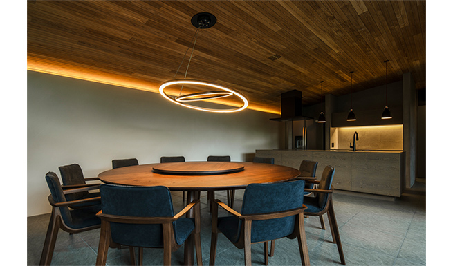 ダイニングよりキッチンを望む。円卓はカスタムメード。